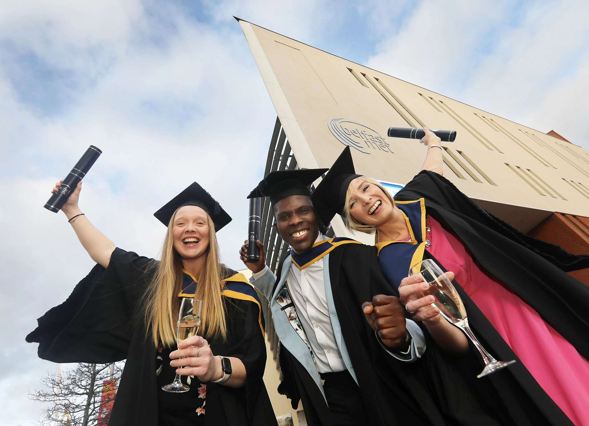 Delighted Graduates Outside Belfast Met's Titanic Quarter Campus