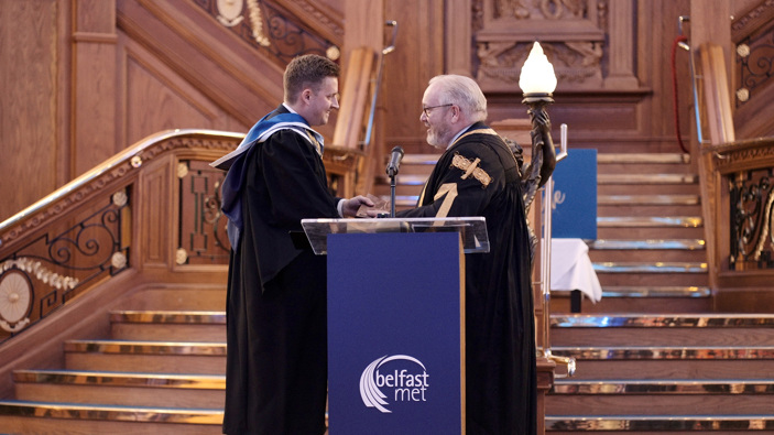 Graeme Craft being presented with his Honorary Fellowship by Damian Duffy interim Principal and Chief Executive of Belfast Met