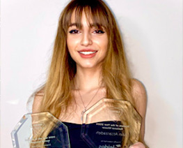 girl smiling holding awards